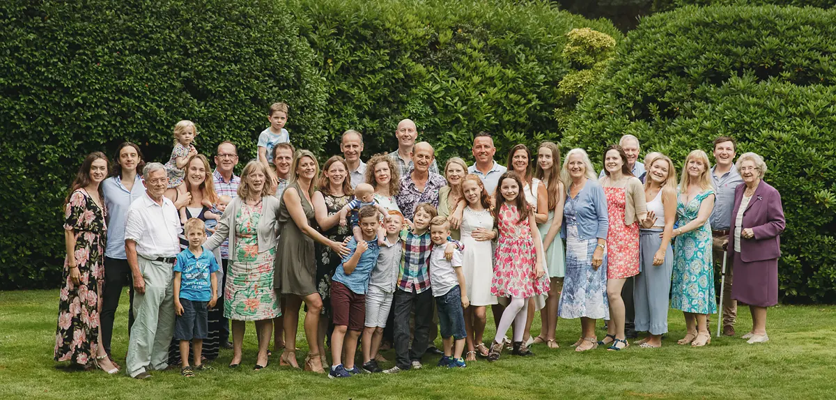 Large extended family group photographed outdoors at a milestone birthday gathering in Dorset.
