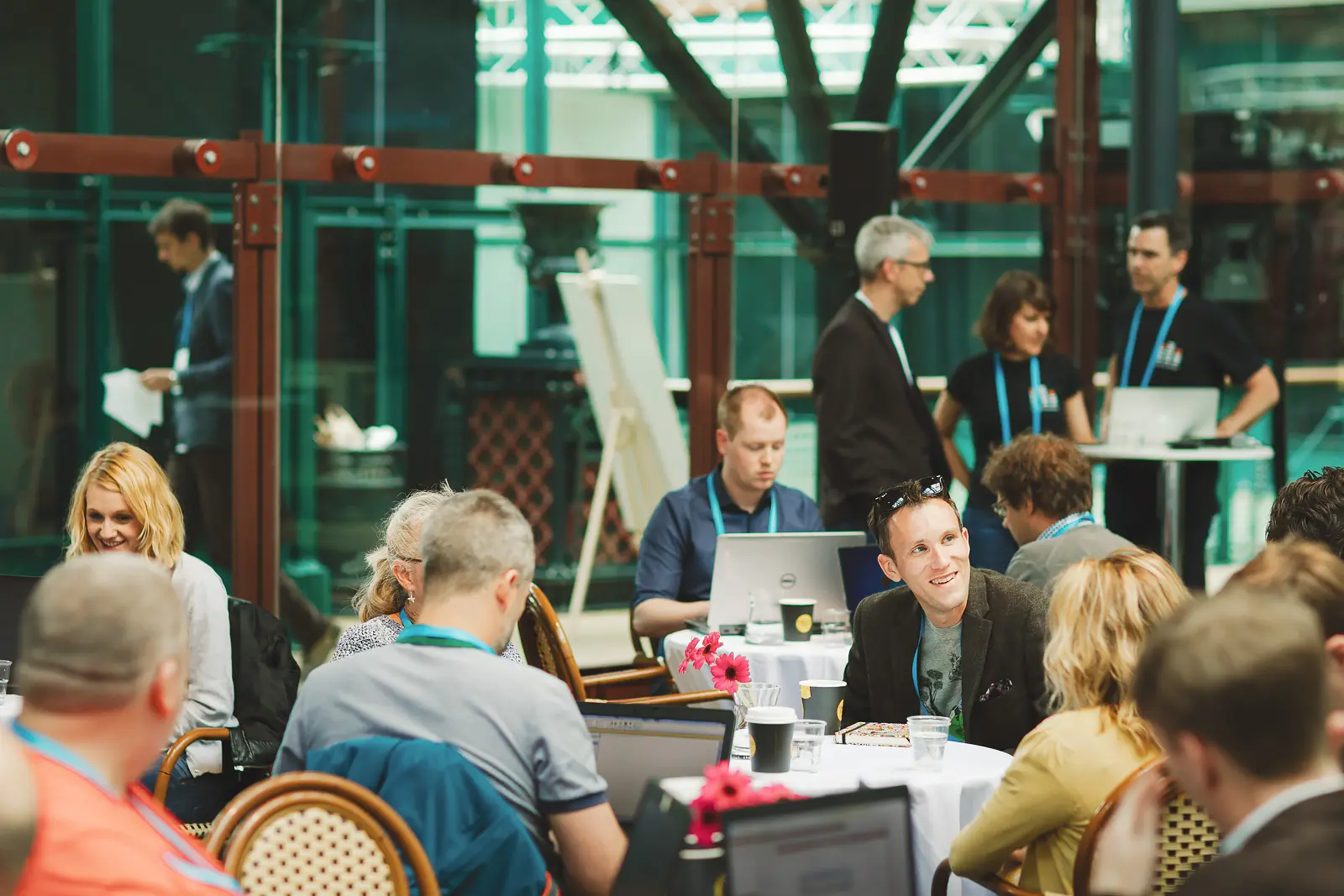 Corporate event guests networking during a conference at Tobacco Dock in Wapping, London