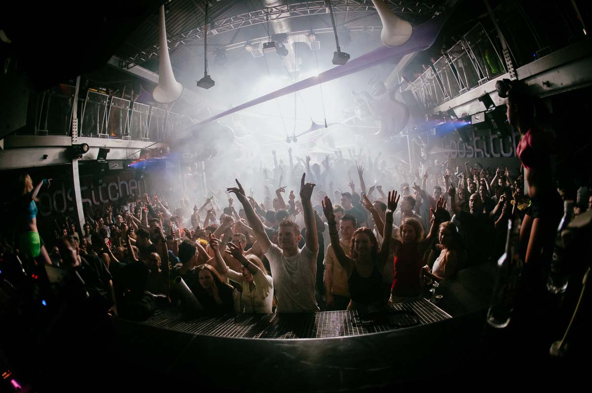 Crowd with hands raised on a packed UK superclub dancefloor, photographed from the stage during the late 90s and 2000s dance music era.