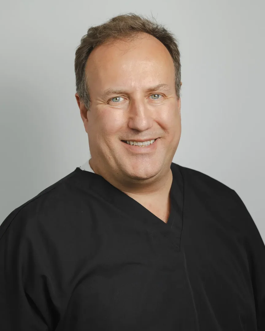 Professional headshot of a Bournemouth dentist photographed for practice branding.