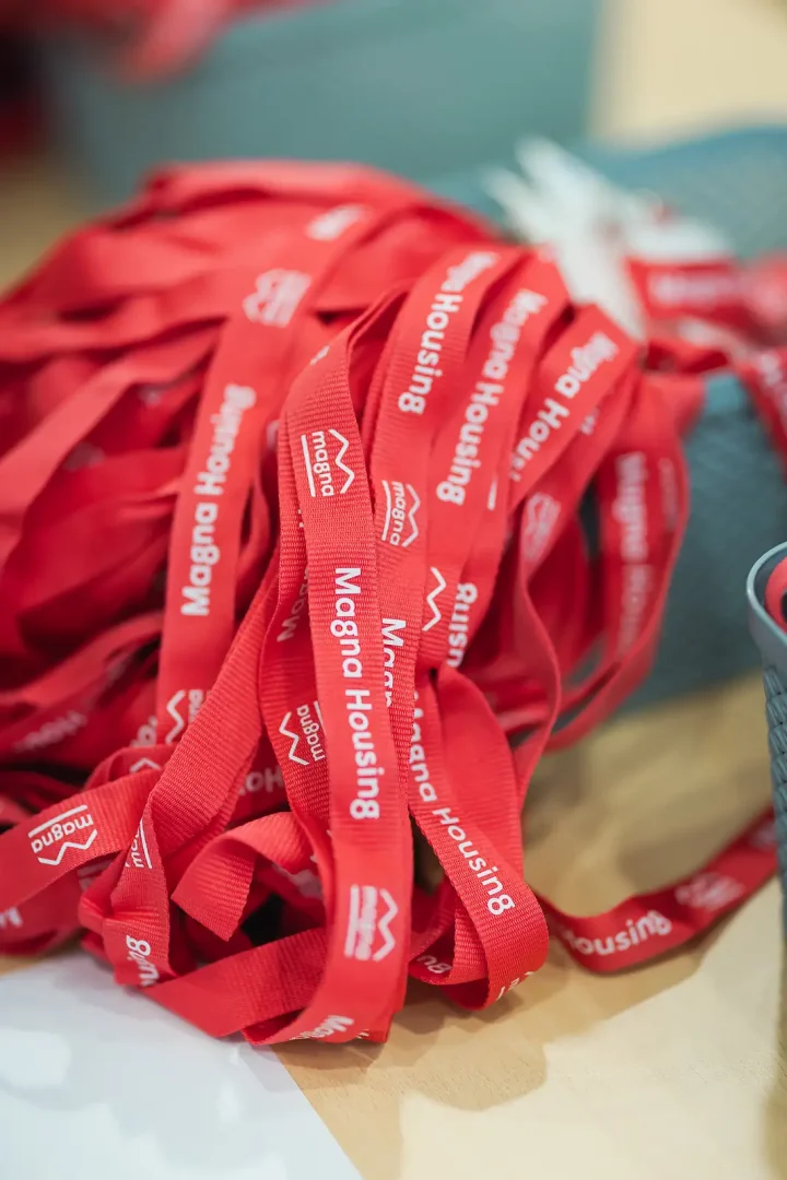 Branded red lanyards piled on a table at a corporate away day in Somerset
