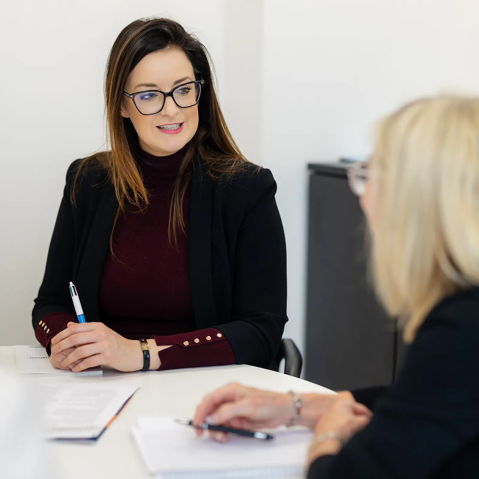 Branding photography in Bournemouth showing a professional business consultation between two women in a bright office setting