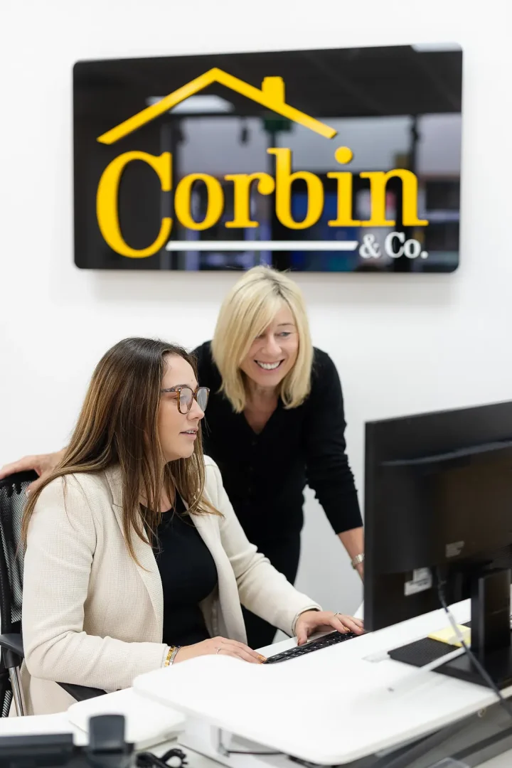 Estate agency team working together at a computer during a Bournemouth branding photography shoot.