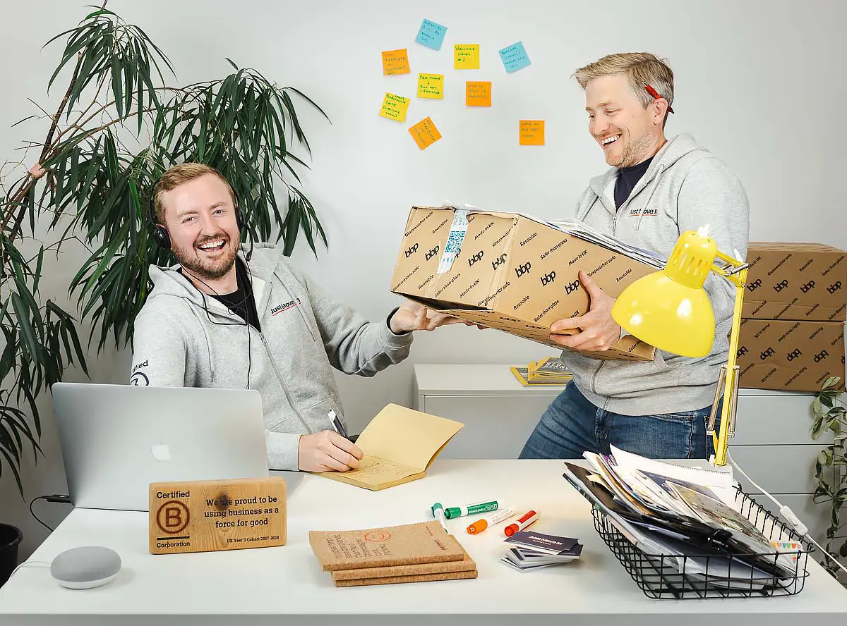 Branding photography in Bournemouth showing two team members working together in a relaxed office environment.