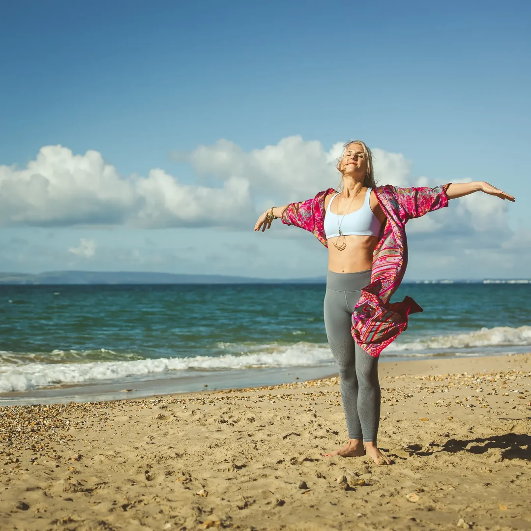 Wellness coach photographed on the beach near Bournemouth during a personal branding photography shoot.