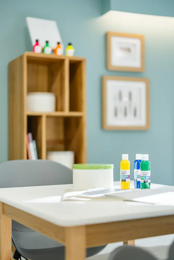 Paints and creative materials photographed in a workspace for a Dorset branding photography shoot.