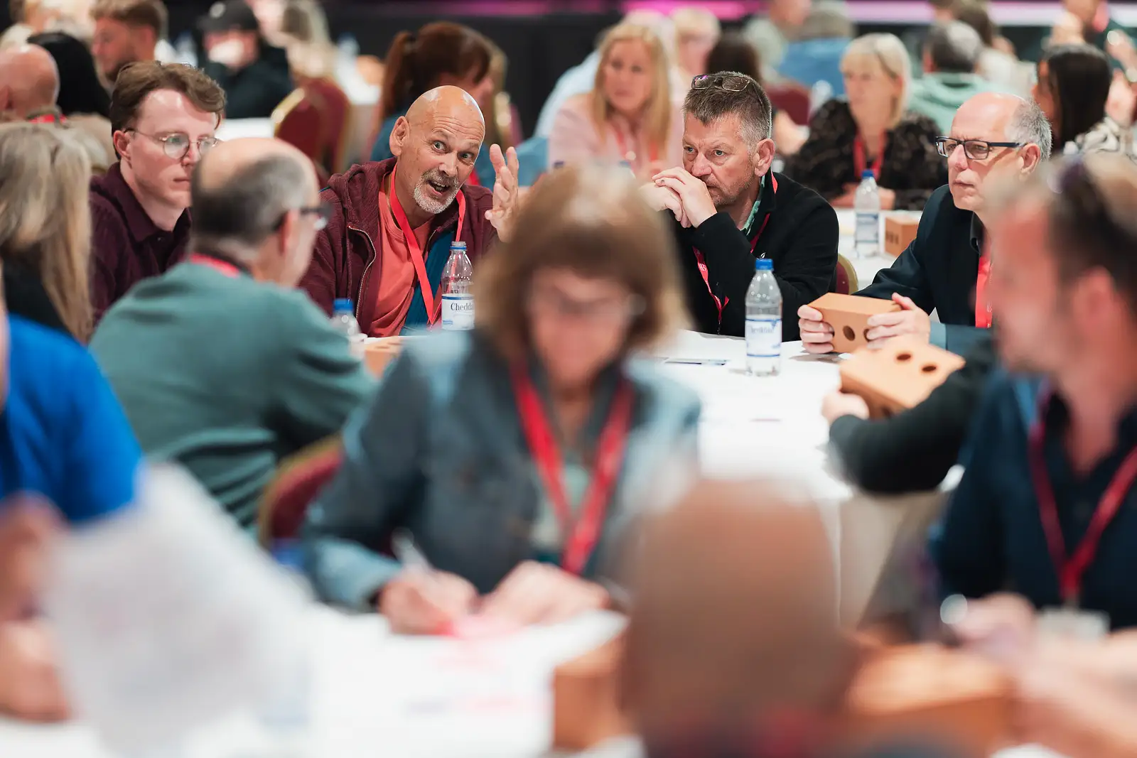 Busy room of colleagues in animated group discussions during workshop sessions at a corporate event at Westlands Theatre