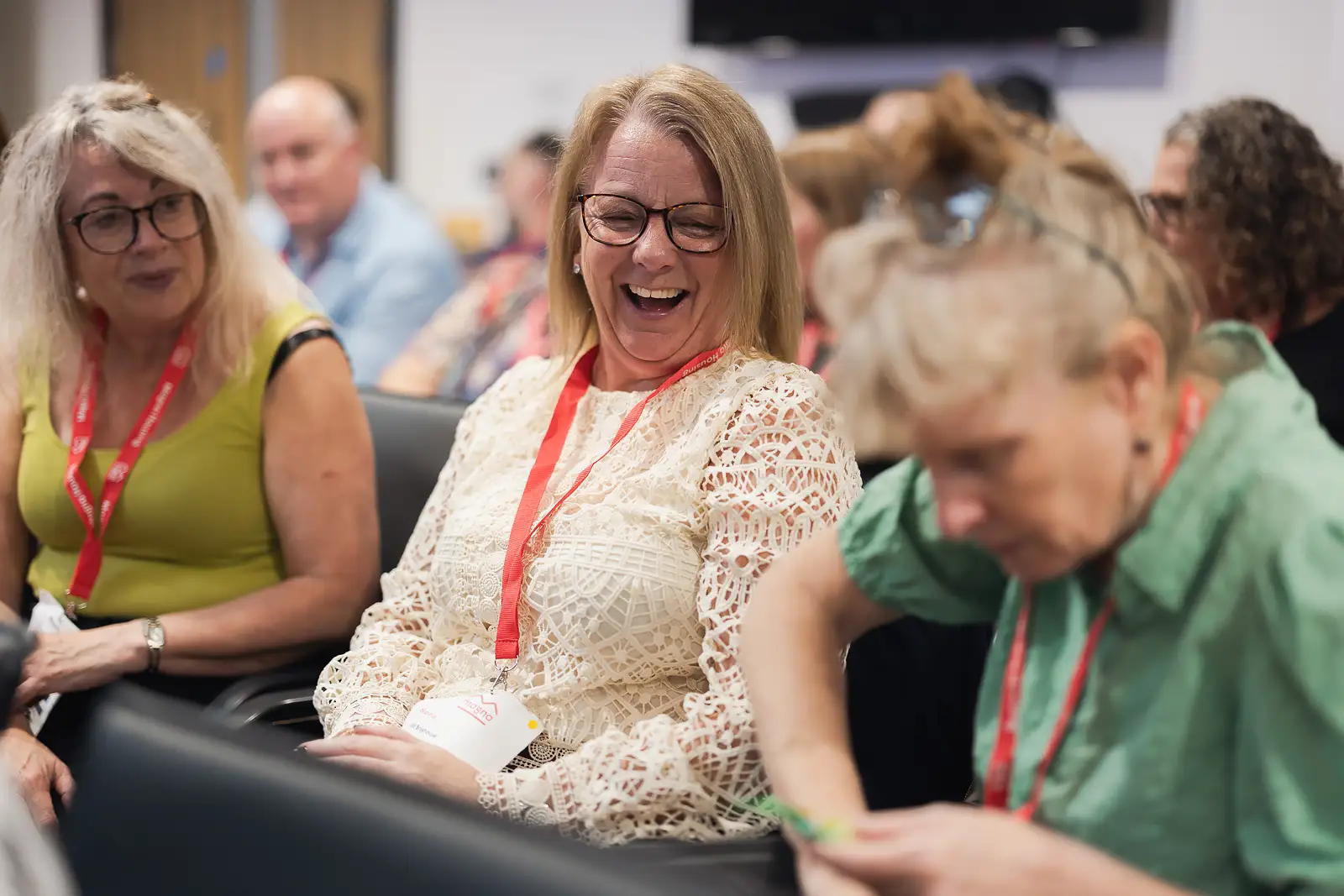 Colleague laughing openly during a workshop session at a corporate event in Somerset surrounded by fellow delegates