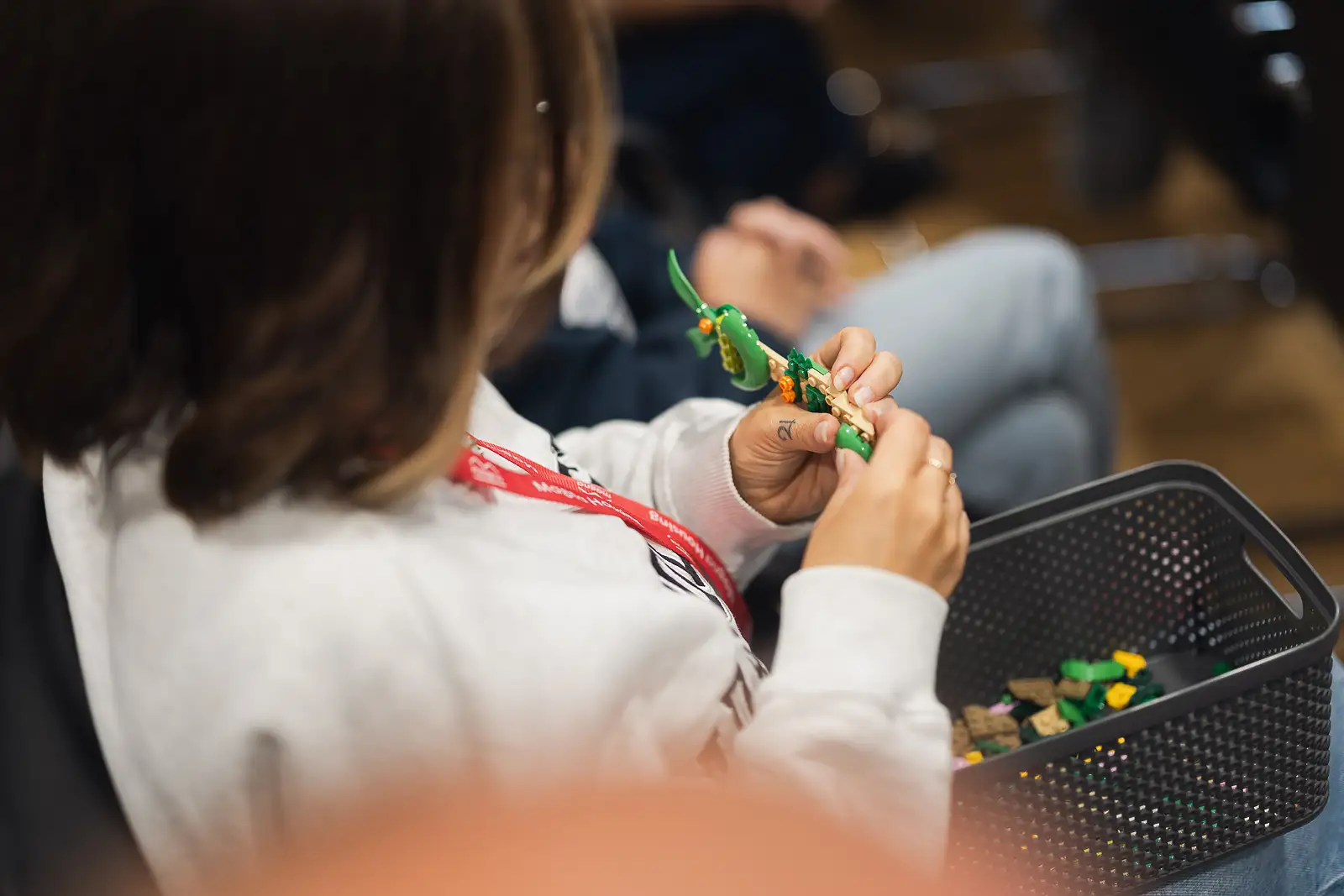 Close detail of a delegate assembling a construction activity during a team workshop at a corporate away day