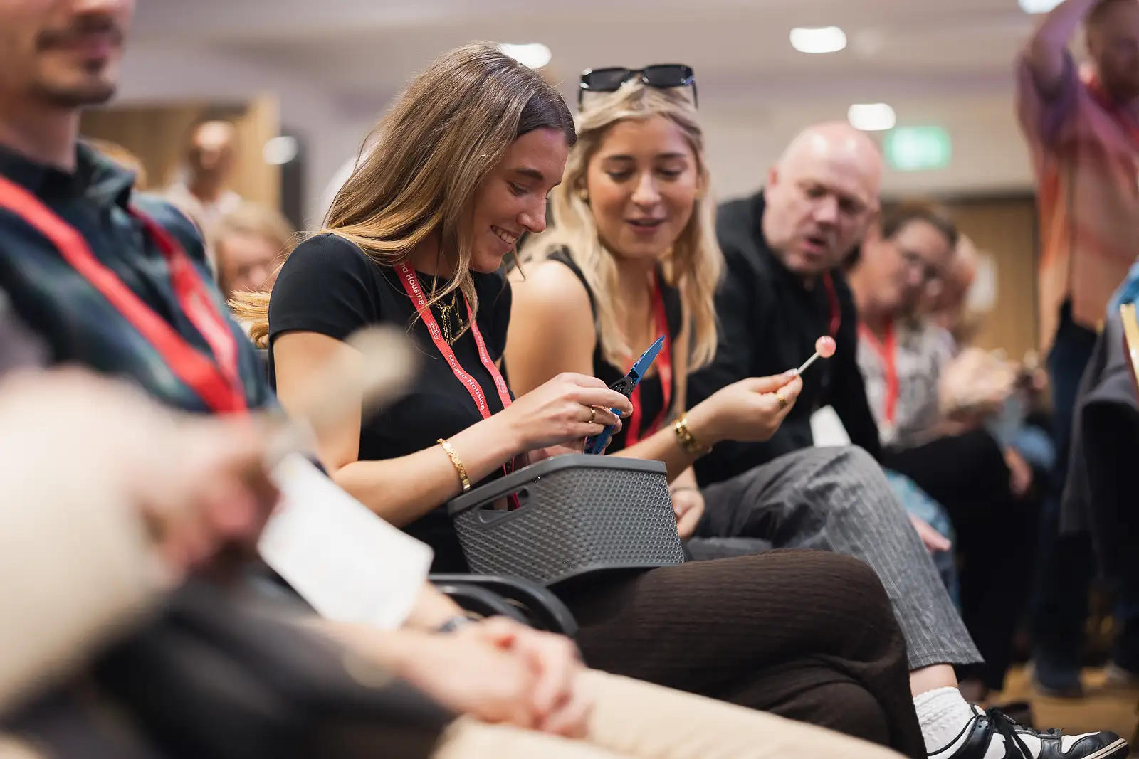 Delegates smiling while working on an interactive activity at a corporate event at Westlands Theatre Somerset