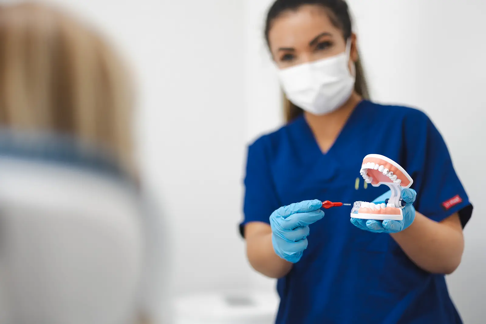 Dental team member explaining oral care to a patient during a Bournemouth branding photography shoot.