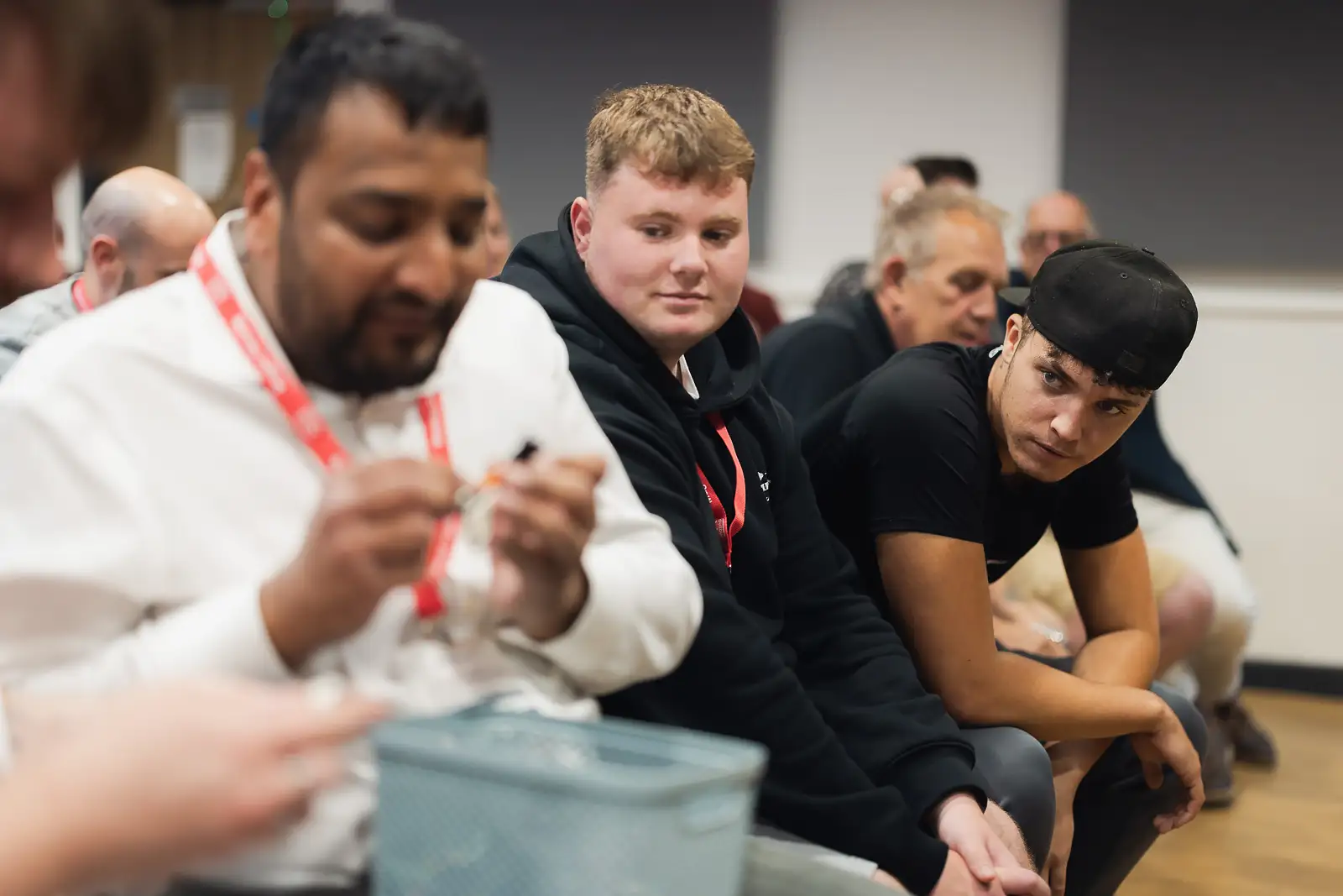 Employees focused and engaged during an interactive session at a corporate event, documentary style corporate event photography