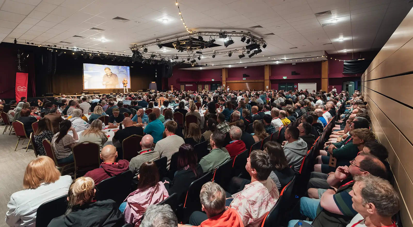 Full auditorium of delegates watching a keynote speaker during a corporate away day at Westlands Theatre Somerset