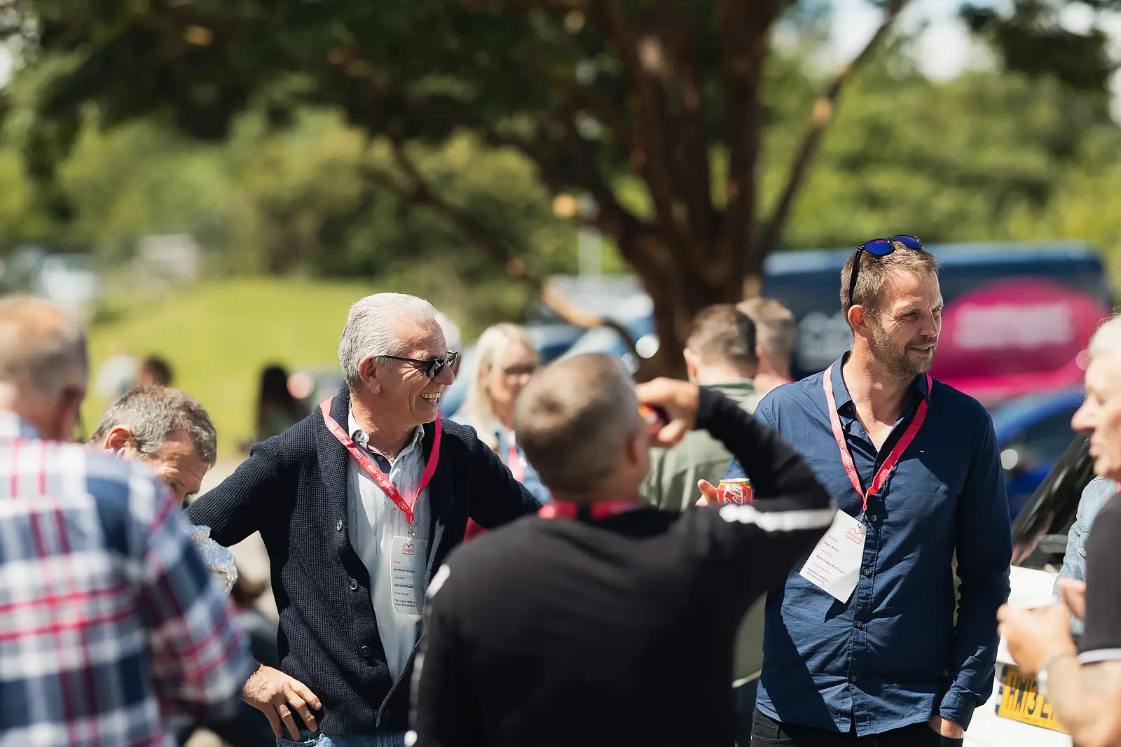 Colleagues socialising in the sunshine during an outdoor break at a corporate away day in Yeovil Somerset