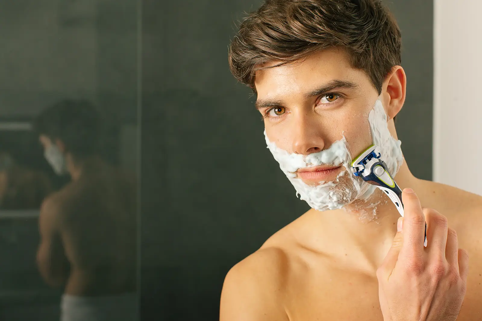 Man mid-shave with foam on his face, styled for a Bournemouth advertising photography campaign