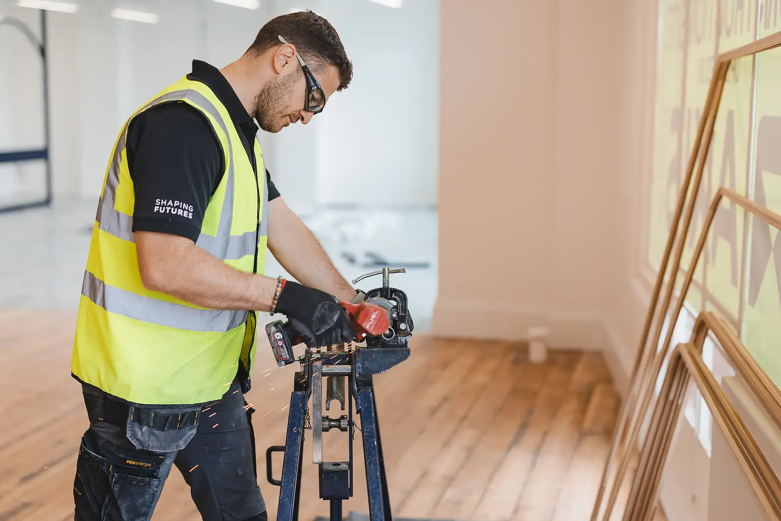 Tradesman working at a vice with sparks flying, captured for a Dorset brand campaign