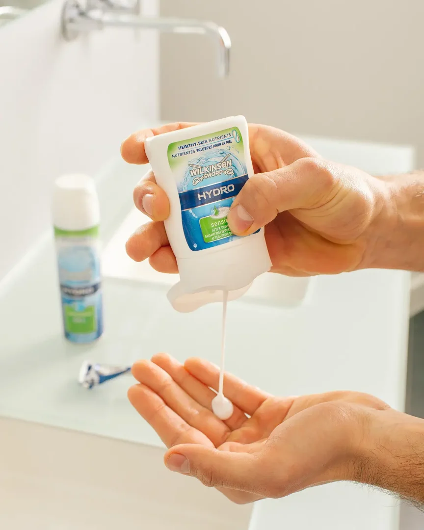 Hand squeezing balm into an open palm beside a razor, captured for a Bournemouth campaign photography shoot