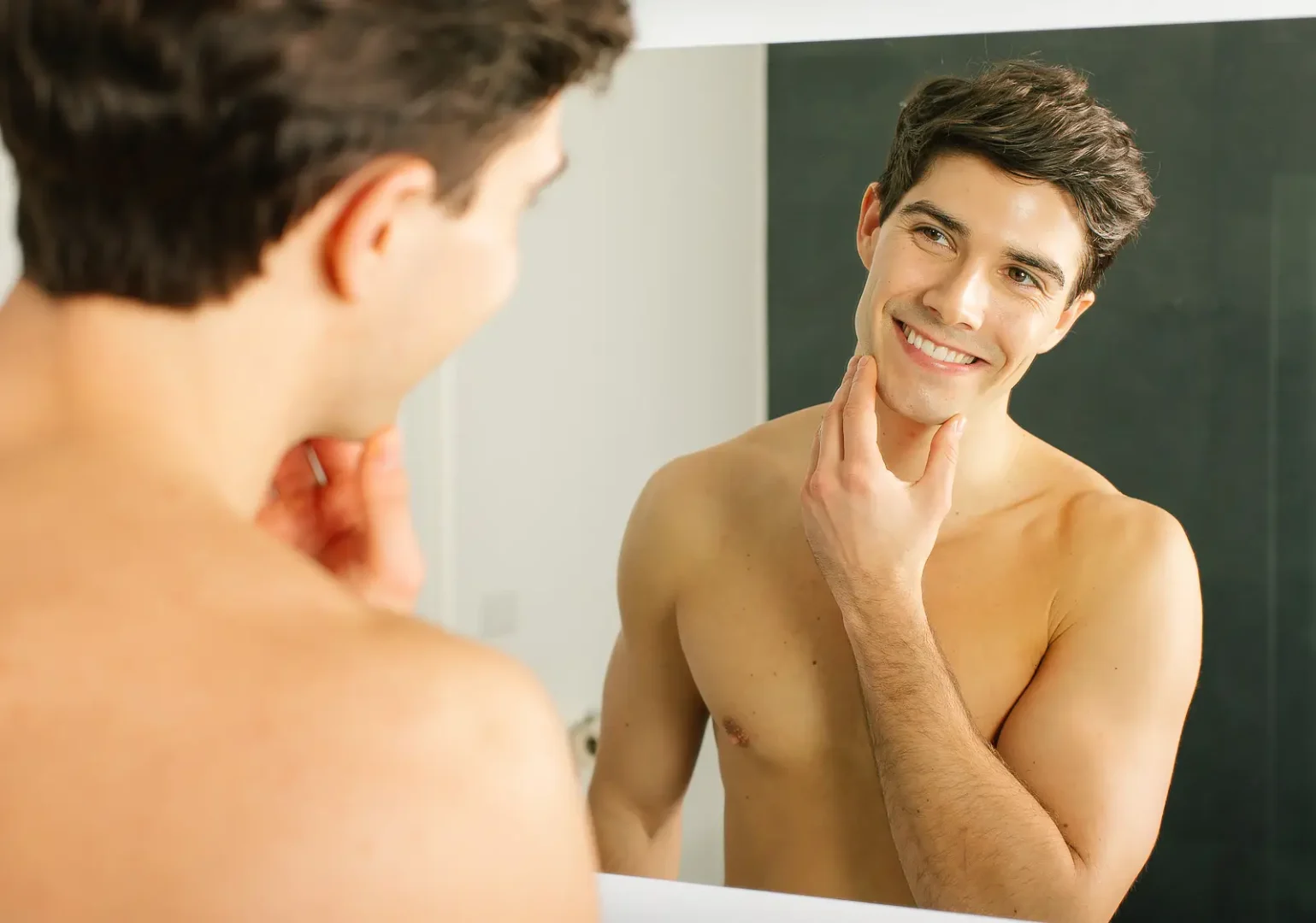 Man smiling while touching his freshly shaved chin, from a Bournemouth commercial photography shoot