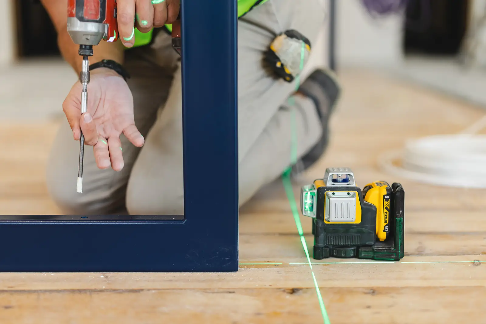 Close-up of hands drilling into a window frame on site, from a Bournemouth product photography shoot