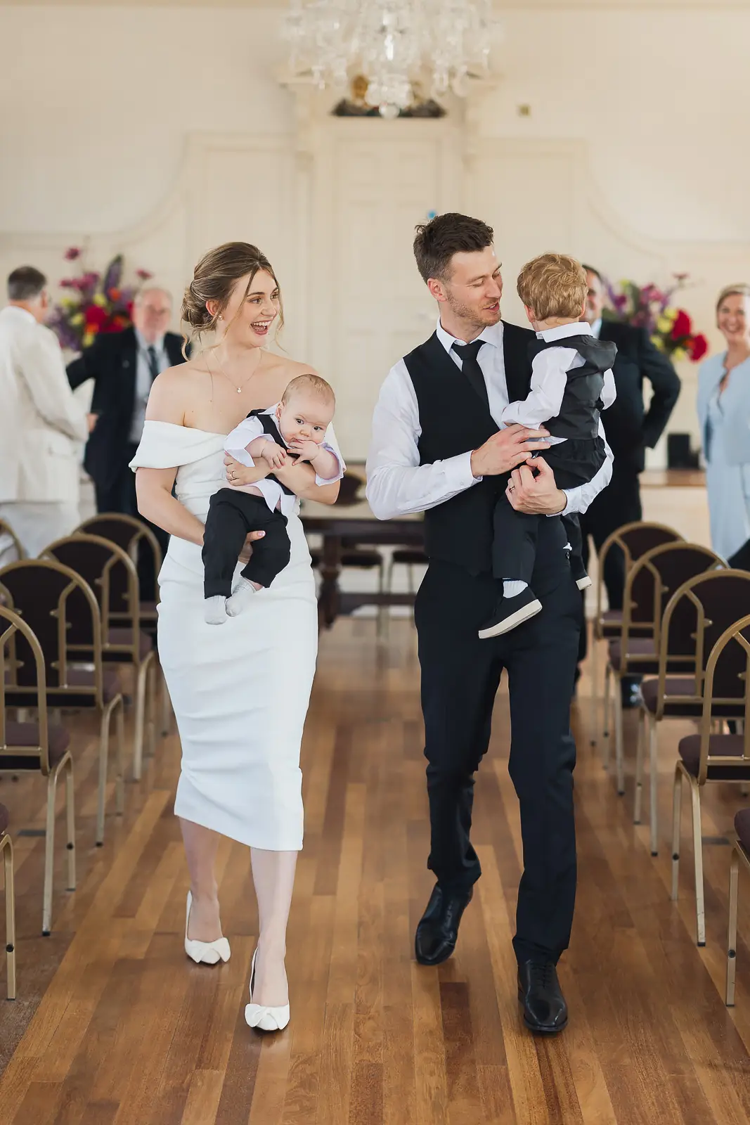Couple walking down the aisle at Guildhall Poole after wedding ceremony