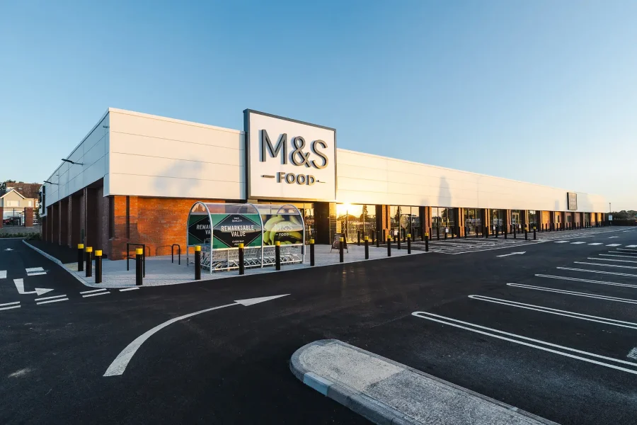 Commercial exterior photography of the Poole store, showing the glazed frontage and entrance from across the car park.