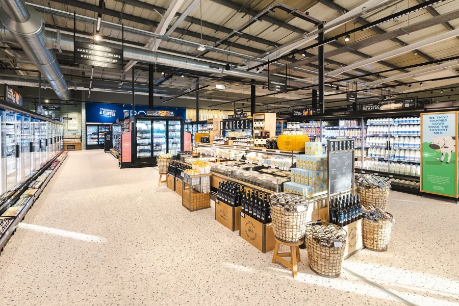 Commercial interior photography of the Poole food hall, showing central display tables and chilled cabinets.