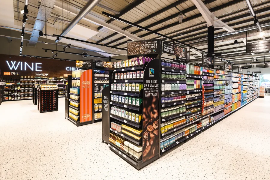 Wide view from the commercial photography shoot in Poole, with stocked aisles, a coffee display and the wine department.