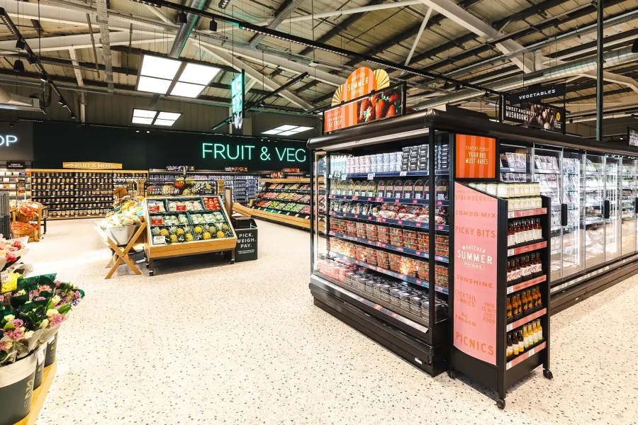 Fresh produce and chilled displays beneath department signage at the new M&S food hall in Poole, Dorset.