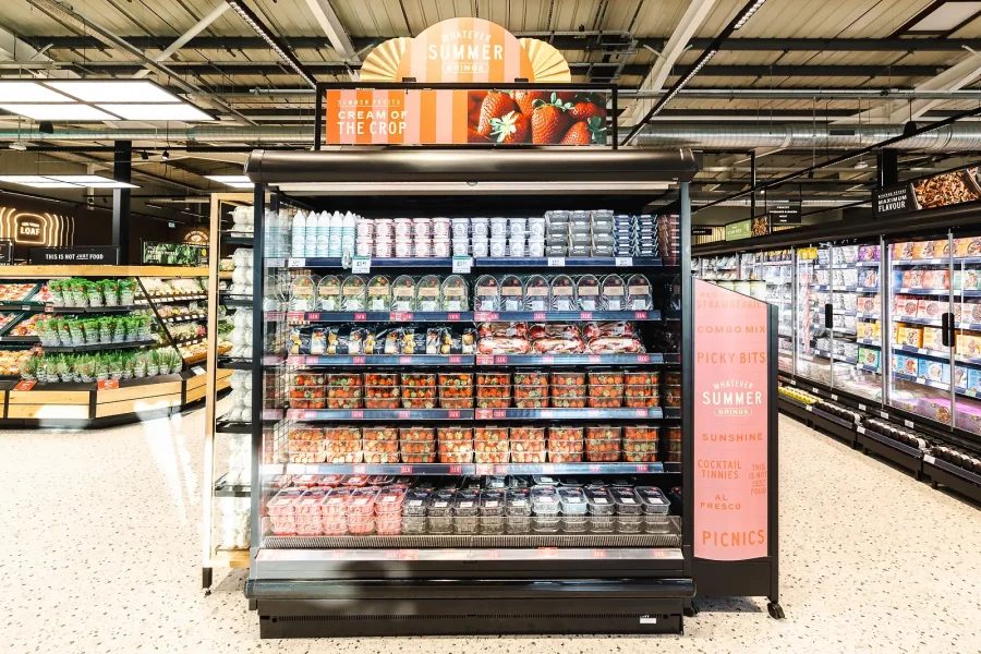 Summer picnic branding above a stocked chilled display, photographed for the Poole store's marketing imagery.
