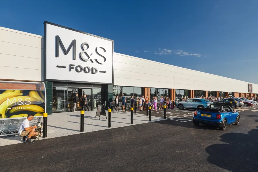 Customers gathering outside the M&S entrance, photographed during store launch coverage in Poole.