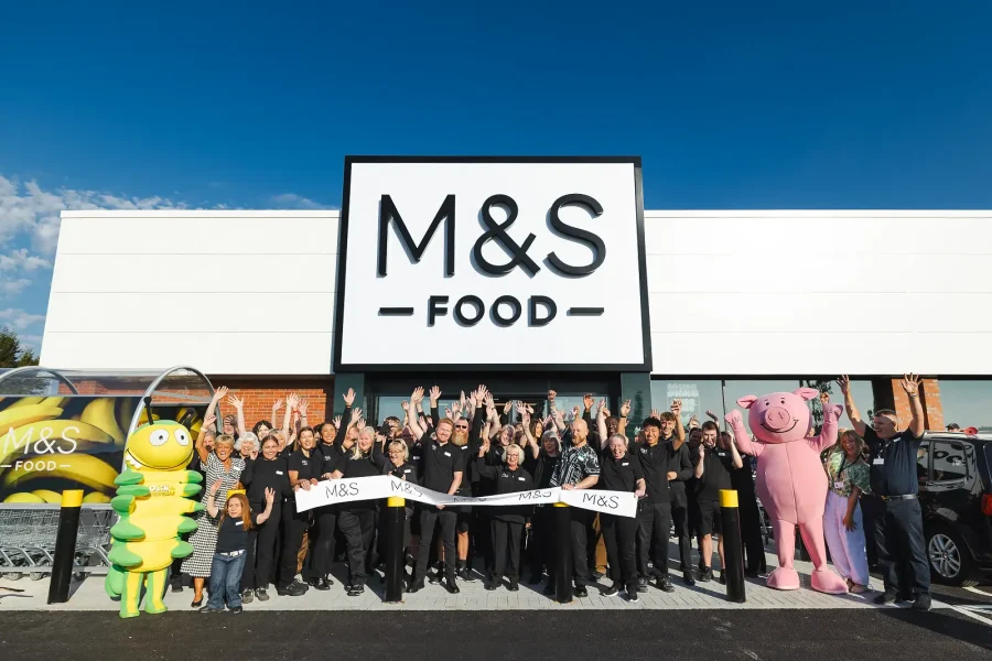 M&S colleagues and character mascots gathered behind the ribbon for the store opening in Poole.